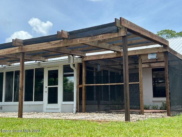1040 Wing Road Southwest Palm Bay, FL 32908 - Photo 40 of 52 a view of a house with a large window and plants