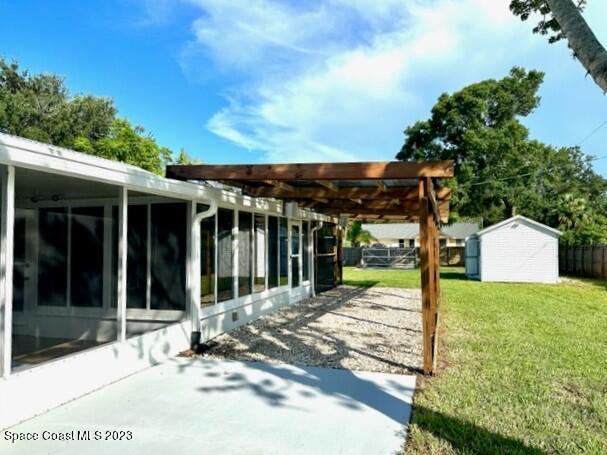 1040 Wing Road Southwest Palm Bay, FL 32908 - Photo 46 of 52 a view of a house with backyard sitting area and garden