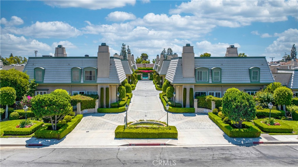 a front view of a residential apartment building with garden