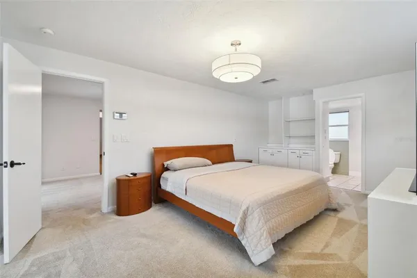 a view of empty room with windows and chandelier