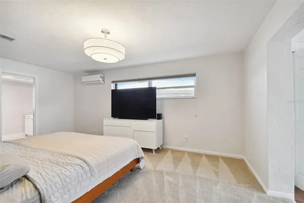 a view of a hallway with wooden floor and closet