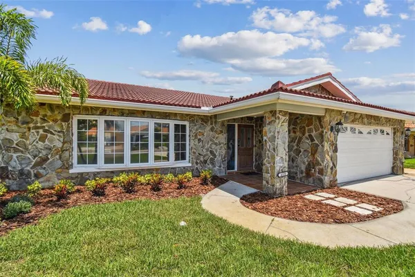 a large kitchen with stainless steel appliances a stove a sink a refrigerator and a granite counter tops