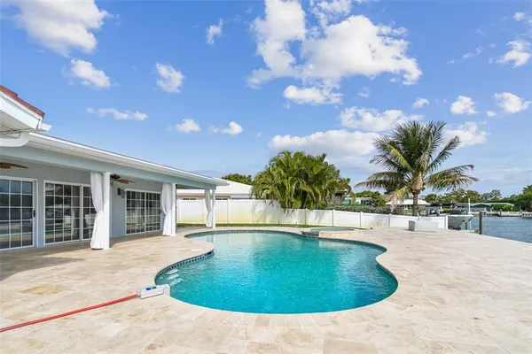 a large kitchen with stainless steel appliances granite countertop a sink and cabinets