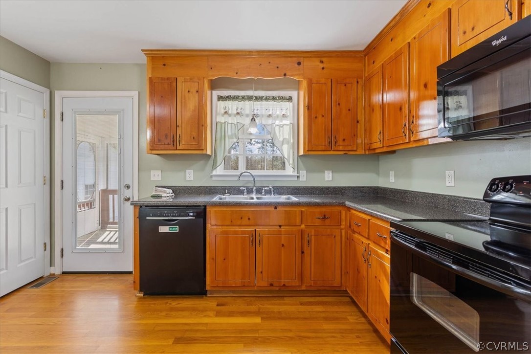 7231 Railroad Bed Road Carson, VA 23830 - Photo 12 of 42 a kitchen with stainless steel appliances granite countertop a stove a sink and a refrigerator