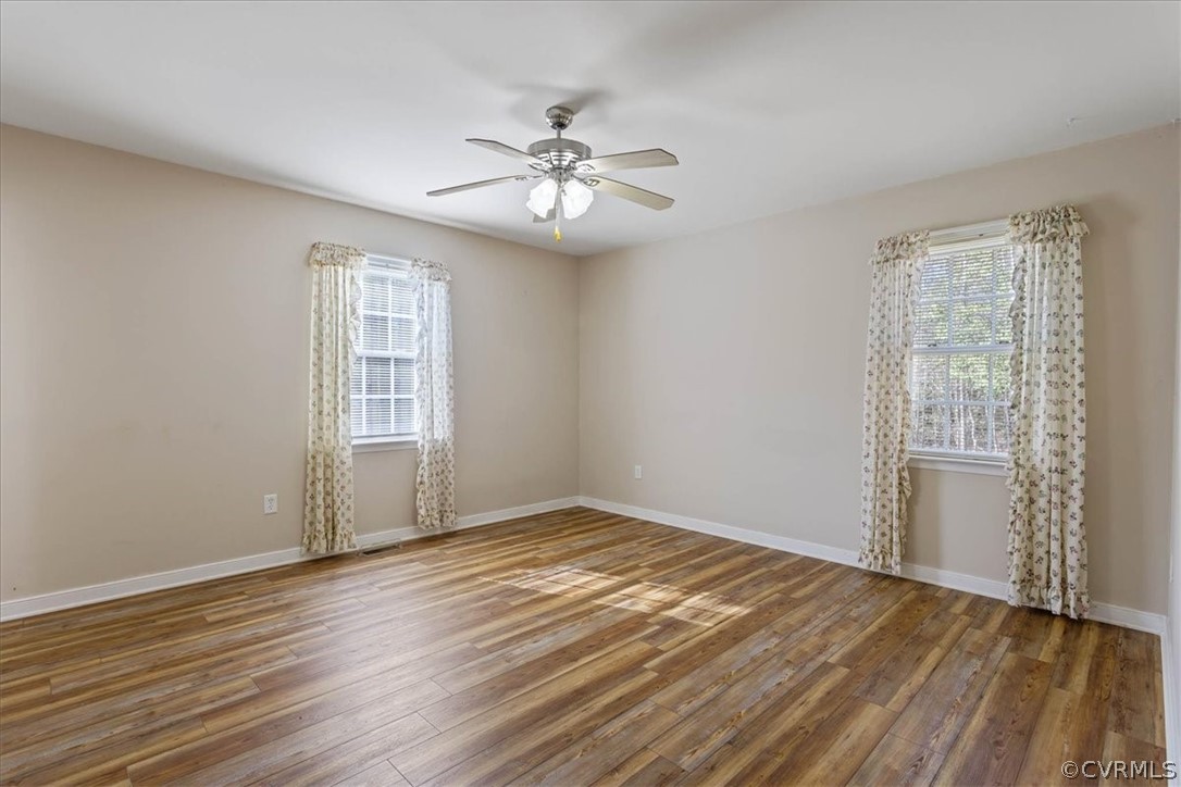 7231 Railroad Bed Road Carson, VA 23830 - Photo 15 of 42 an empty room with wooden floor fan and windows