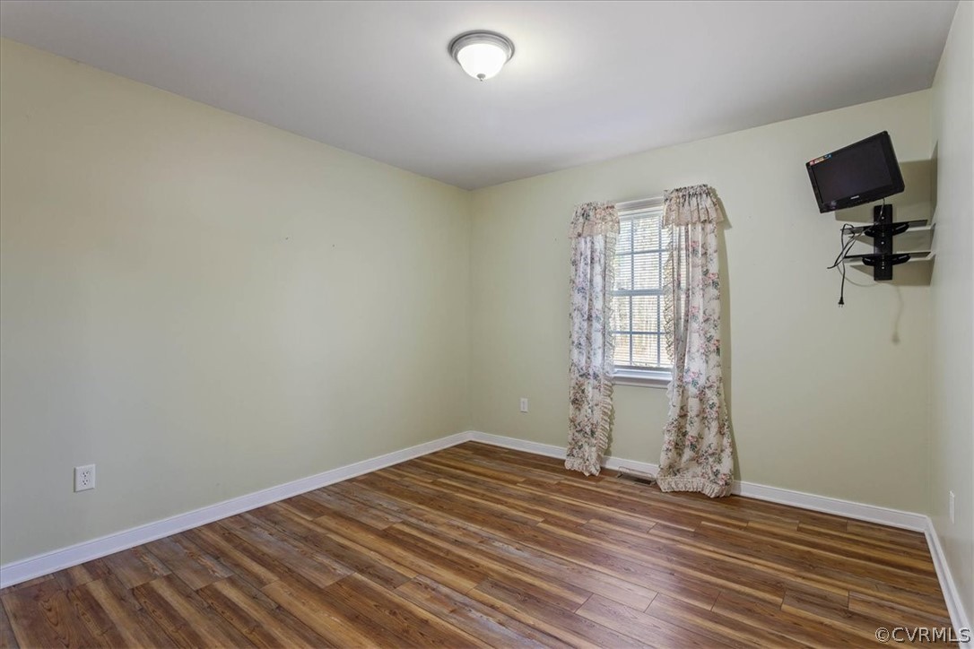 7231 Railroad Bed Road Carson, VA 23830 - Photo 18 of 42 an empty room with wooden floor and windows