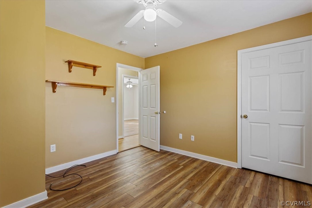 7231 Railroad Bed Road Carson, VA 23830 - Photo 21 of 42 a view of an empty room with wooden floor and a ceiling fan