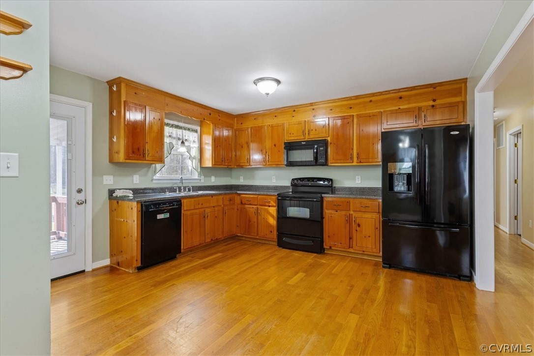 7231 Railroad Bed Road Carson, VA 23830 - Photo 9 of 42 a kitchen with a refrigerator sink and wooden cabinets