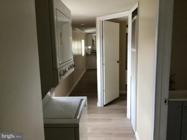 a view of a hallway with furniture and stairs