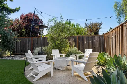 a view of backyard with sitting area and garden