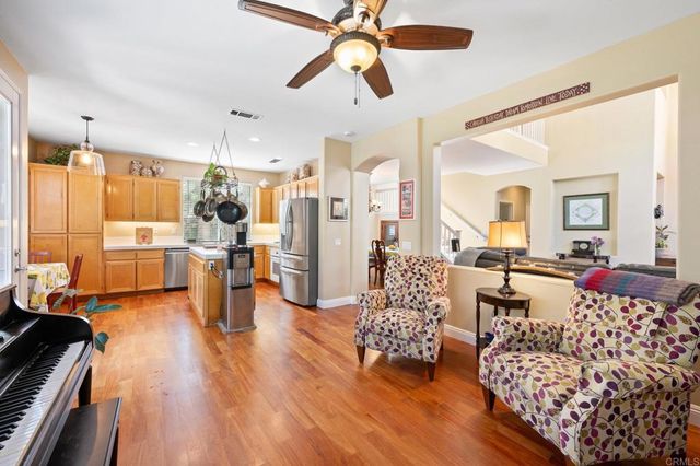 a living room with lots of furniture and a large window