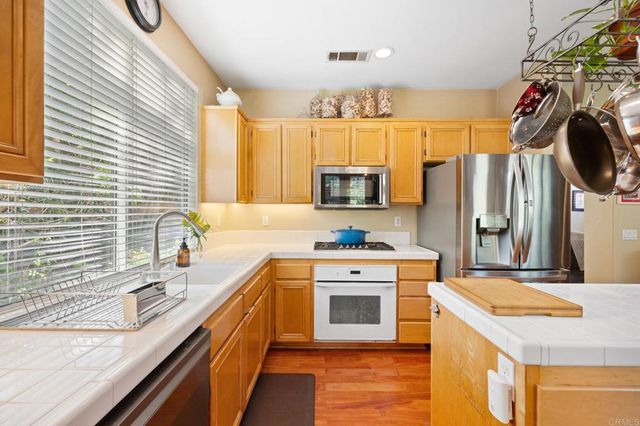 a kitchen with a sink stove and refrigerator