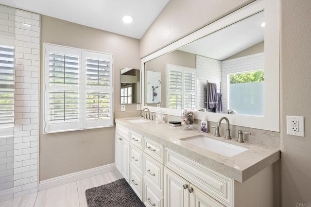 a bathroom with a sink double vanity and a mirror