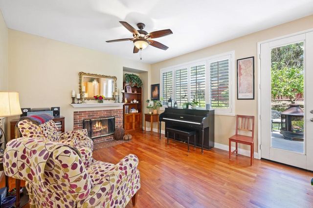 a living room with furniture fireplace and flat screen tv