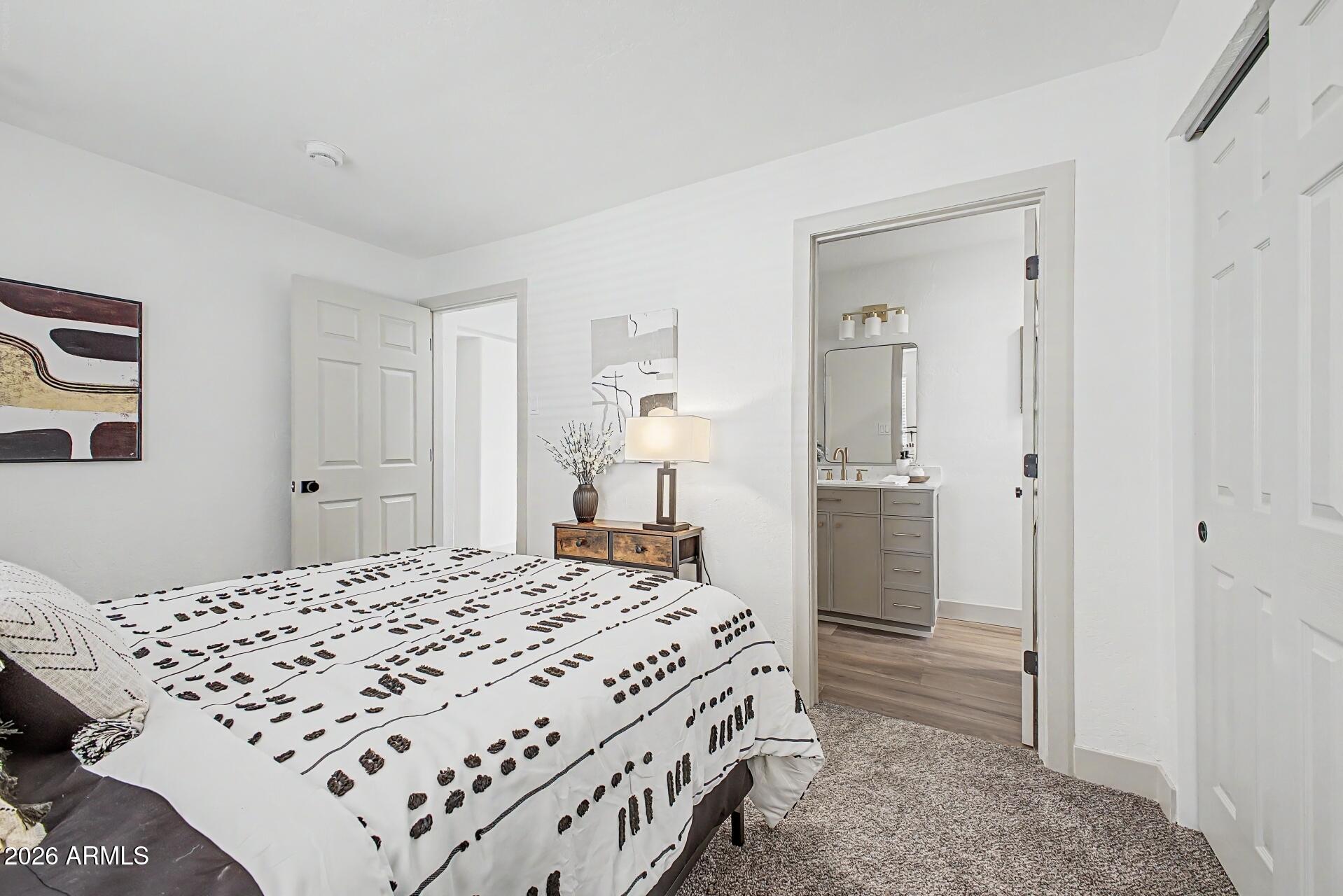 1914 East Monte Vista Road Phoenix, AZ 85006 - Photo 13 of 26 a bedroom with a bed and a mirror