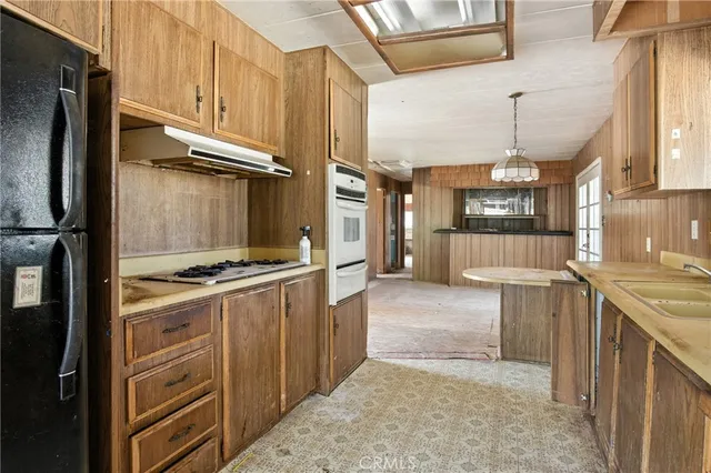 a kitchen with a stove and a refrigerator