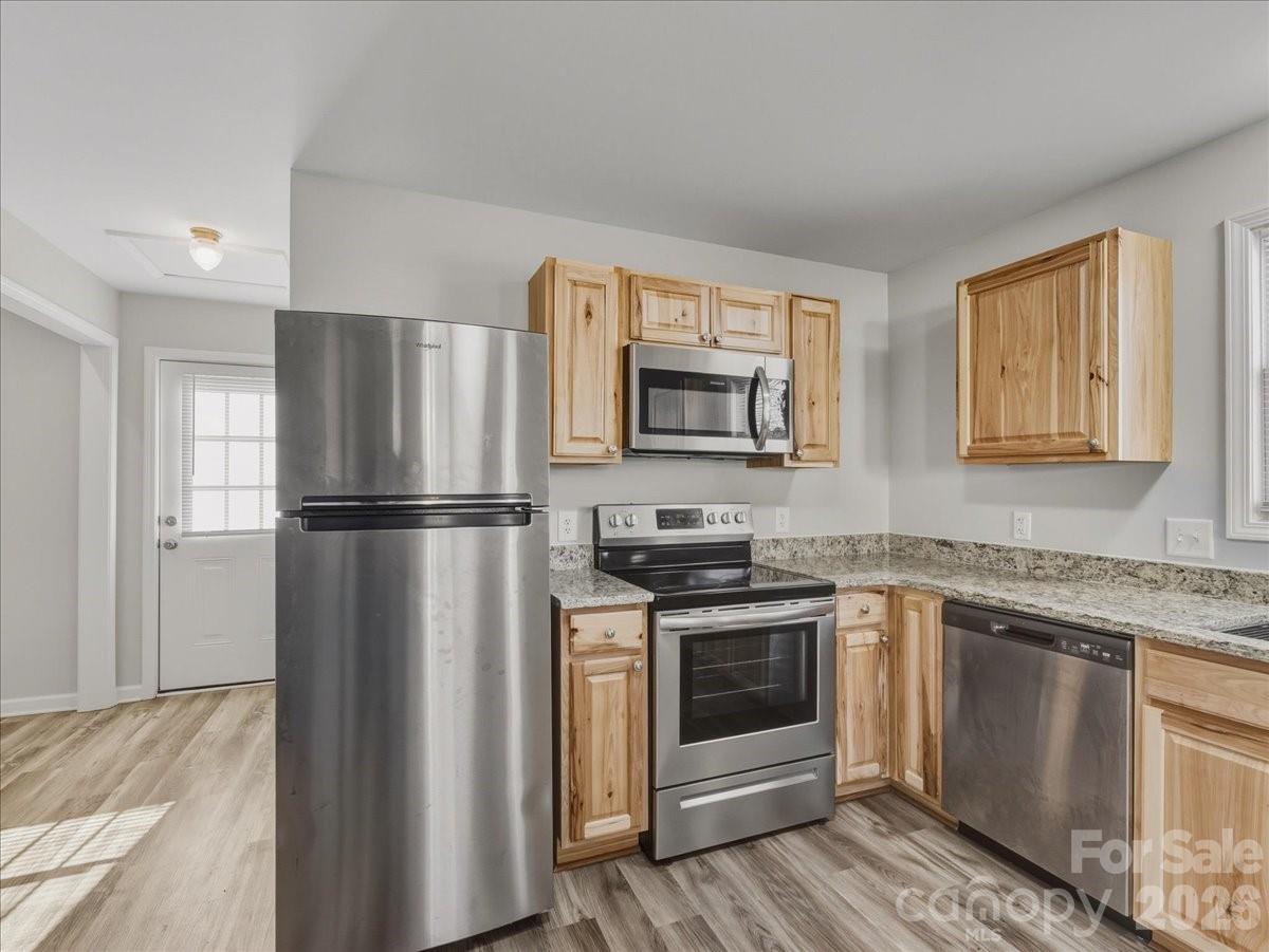 200 Blacksnake Road Stanley, NC 28164 - Photo 11 of 24 a kitchen with stainless steel appliances granite countertop a refrigerator sink and stove
