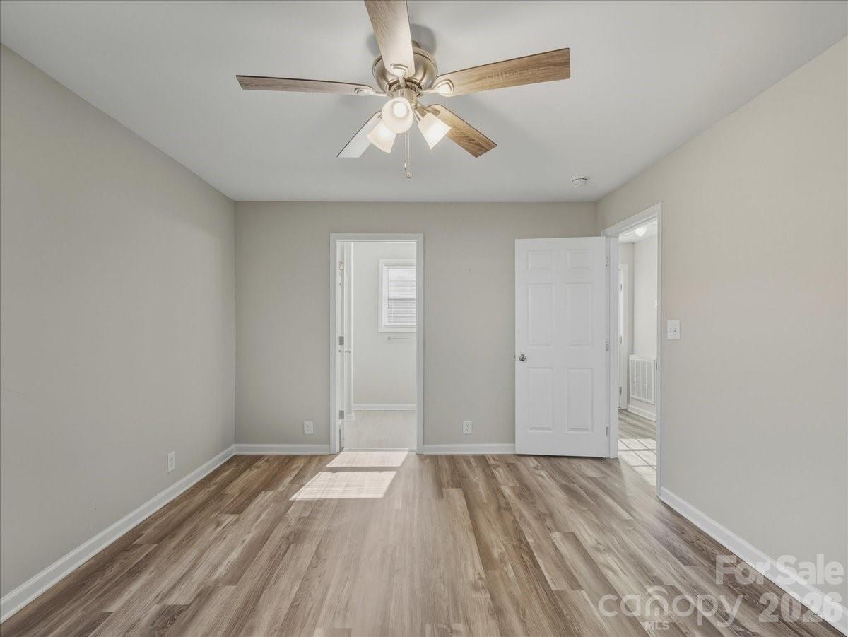 200 Blacksnake Road Stanley, NC 28164 - Photo 14 of 24 an empty room with wooden floor and windows