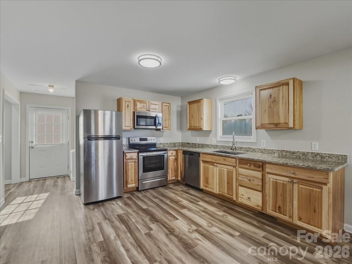 200 Blacksnake Road Stanley, NC 28164 - Photo 9 of 24 a kitchen with stainless steel appliances granite countertop a refrigerator and a stove top oven