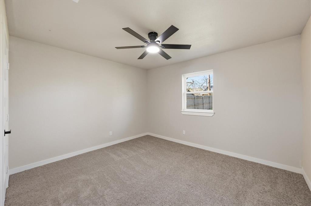 2804 Bent Tree Lane Arlington, TX 76016 - Photo 24 of 32 an empty room with a window and a fan