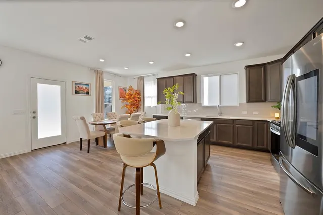 a large kitchen with a table and chairs