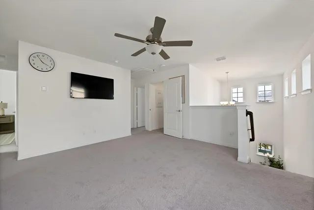 a view of empty room with ceiling fan