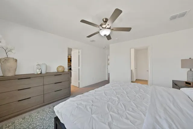 a bedroom with a bed and cabinet