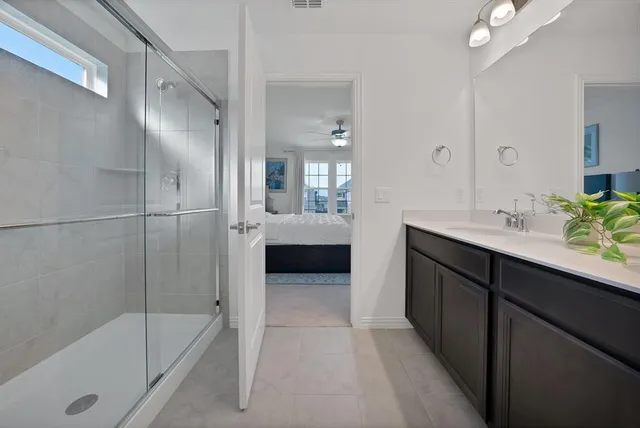 a en suite bathroom with a tub double sink and mirror