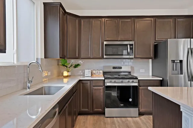 a kitchen with a stove a sink and a microwave