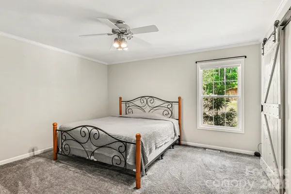 a bedroom with a bed and window