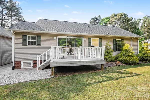 a view of a house with backyard and sitting area