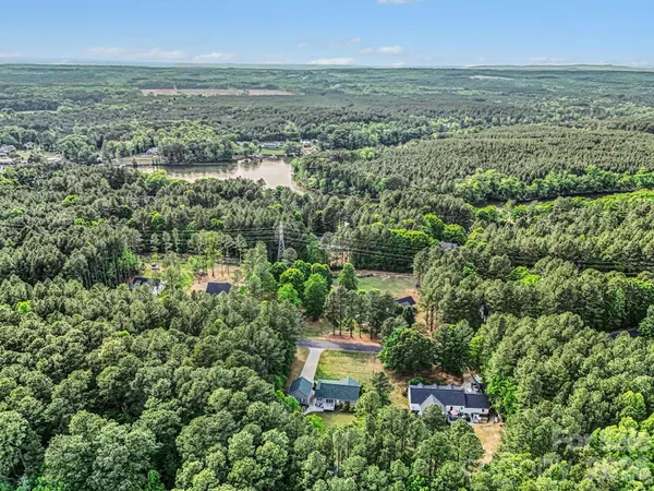 an aerial view of a houses with a yard