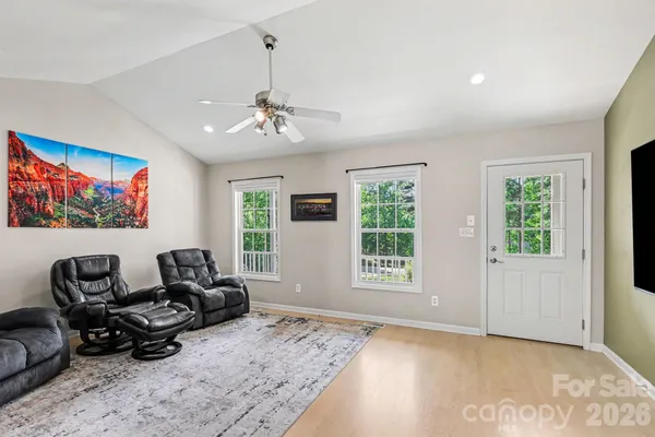 a living room with furniture windows and a flat screen tv
