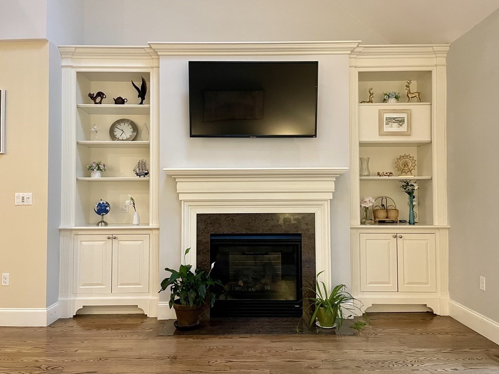 8 Graystone Circle Winchester, MA 01890 - Photo 12 of 41 a living room with flat screen tv and a fireplace