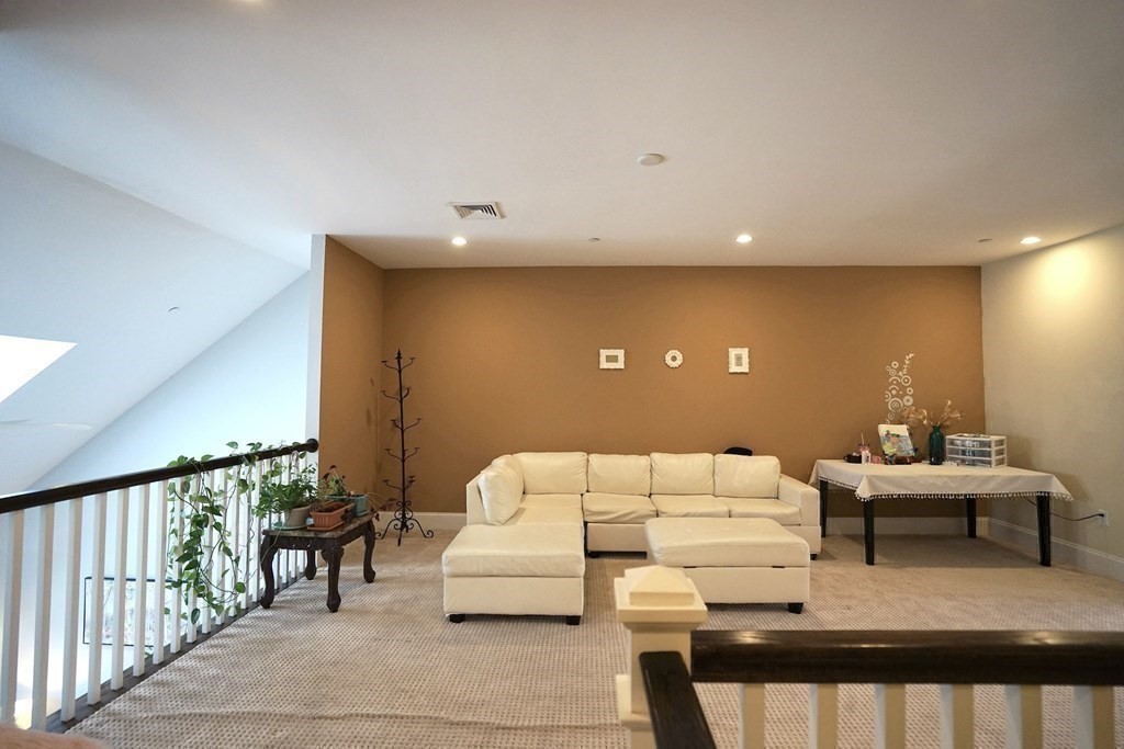 8 Graystone Circle Winchester, MA 01890 - Photo 23 of 41 a living room with furniture and a potted plant