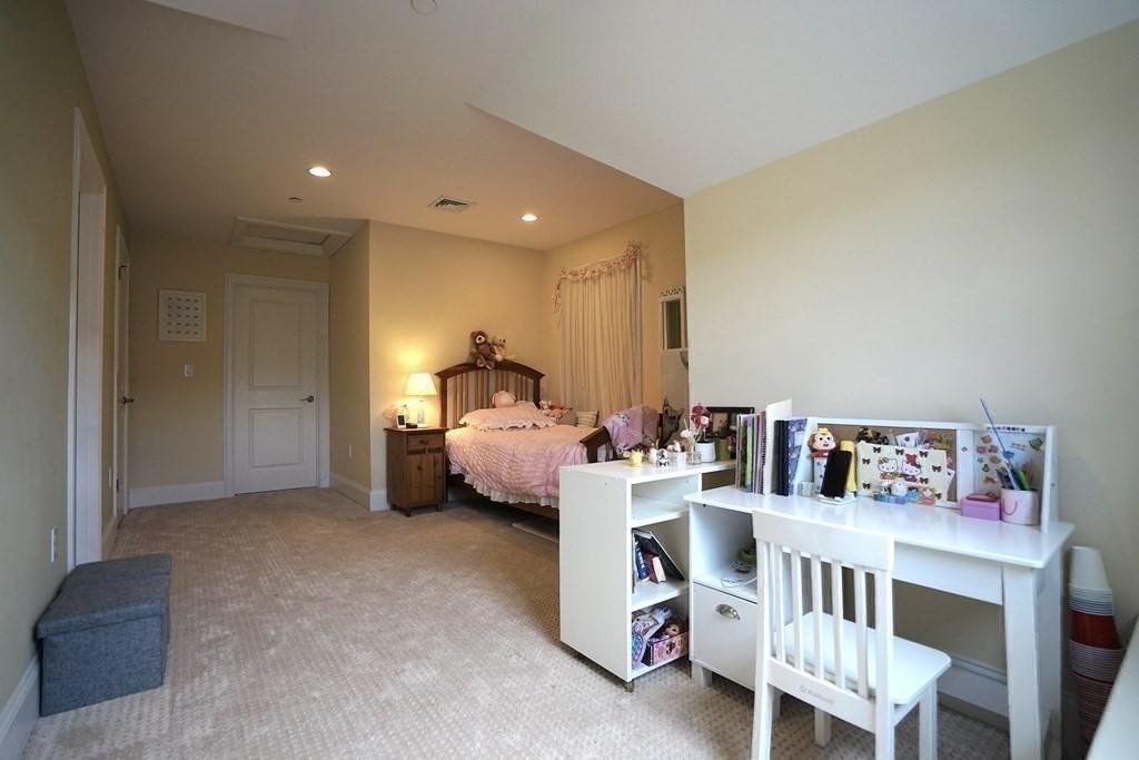 8 Graystone Circle Winchester, MA 01890 - Photo 29 of 41 a living room with furniture and a baby crib