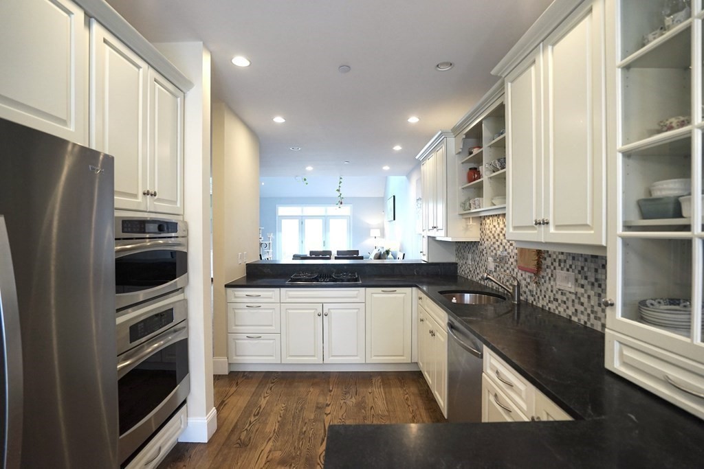 8 Graystone Circle Winchester, MA 01890 - Photo 4 of 41 a kitchen with stainless steel appliances granite countertop a refrigerator a stove and a sink