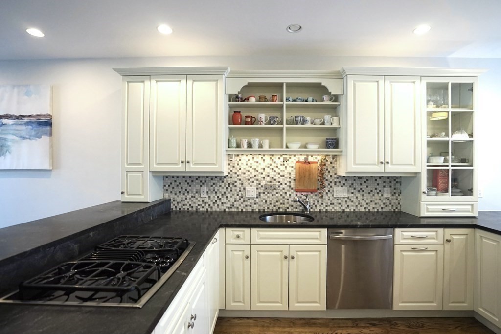 8 Graystone Circle Winchester, MA 01890 - Photo 5 of 41 a kitchen with granite countertop a stove and white cabinets