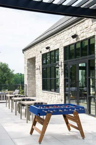 a view of a patio with table and chairs with wooden floor and fence