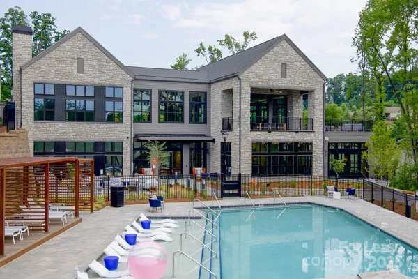 a front view of a house with swimming pool and porch