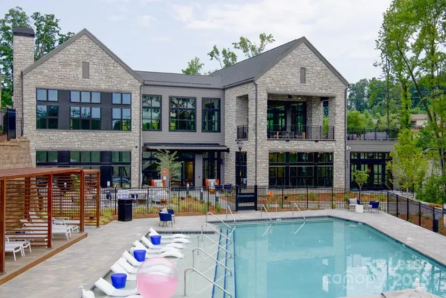 a front view of a house with swimming pool and porch