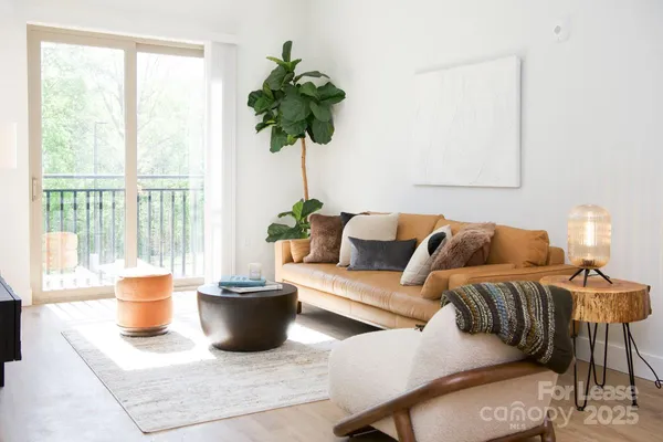a kitchen with stainless steel appliances a stove a sink a refrigerator a center island and chairs