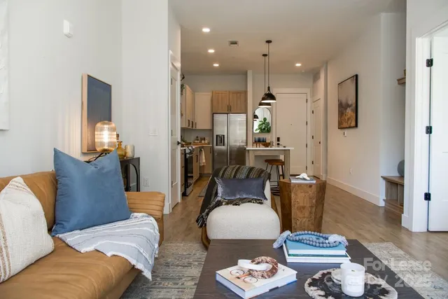 a kitchen with stainless steel appliances a stove a sink a center island and a windows