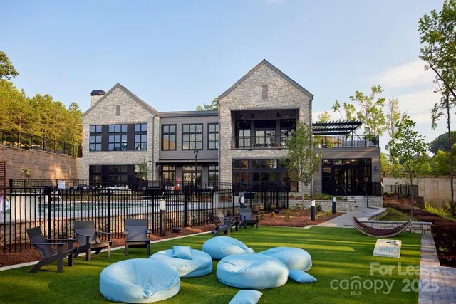 a front view of a house with swimming pool garden and patio