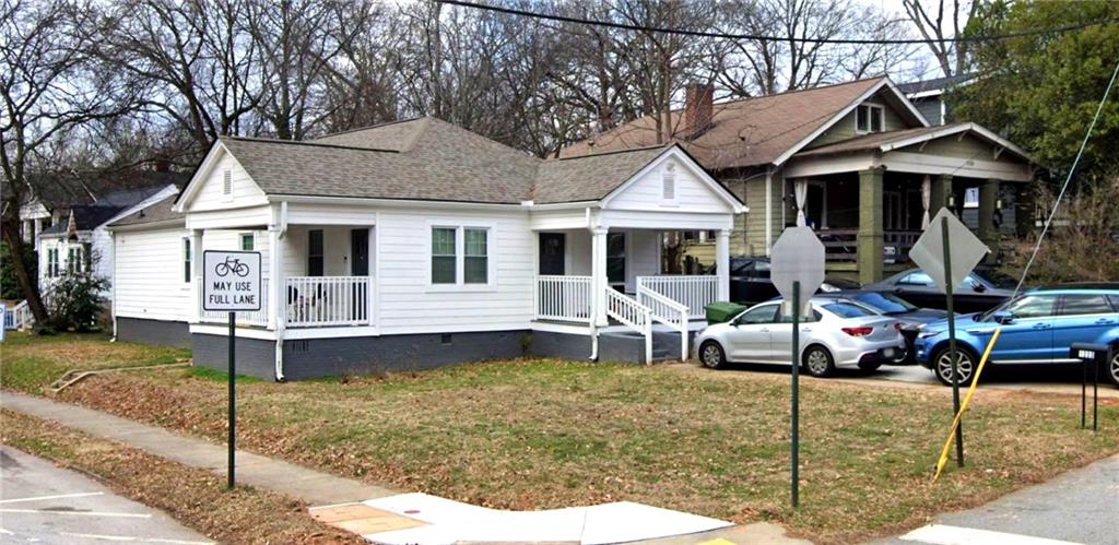 a front view of a house with a yard patio and swimming pool
