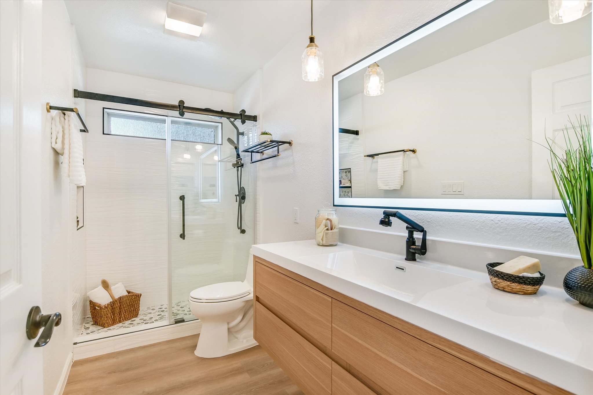 9905 Richelieu Road Austin, TX 78750 - Photo 15 of 32 Full bath with vanity, a shower stall, and light wood look laminate floors