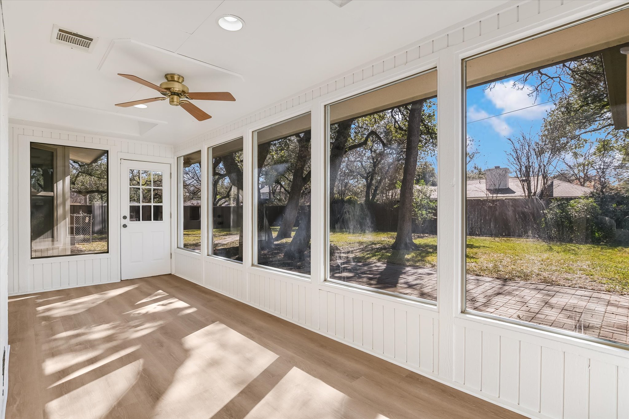 9905 Richelieu Road Austin, TX 78750 - Photo 18 of 32 Sunroom featuring a ceiling fan and expansive view of backyard.