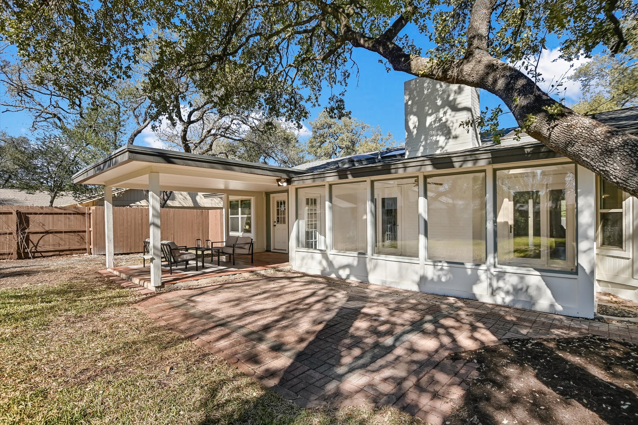 9905 Richelieu Road Austin, TX 78750 - Photo 20 of 32 Back of house featuring a patio and a sunroom