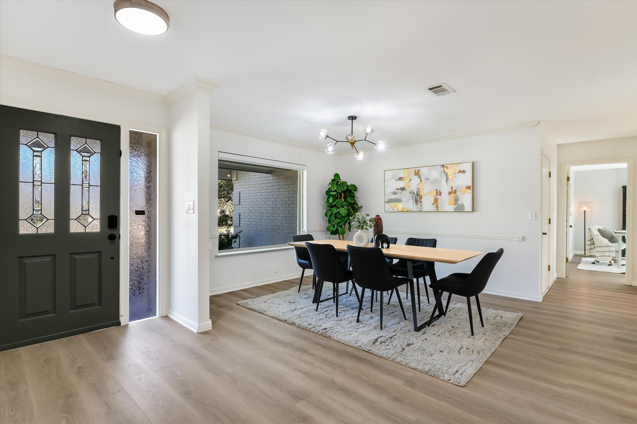 9905 Richelieu Road Austin, TX 78750 - Photo 3 of 32 Dining room featuring light wood-style flooring, a chandelier, and crown molding