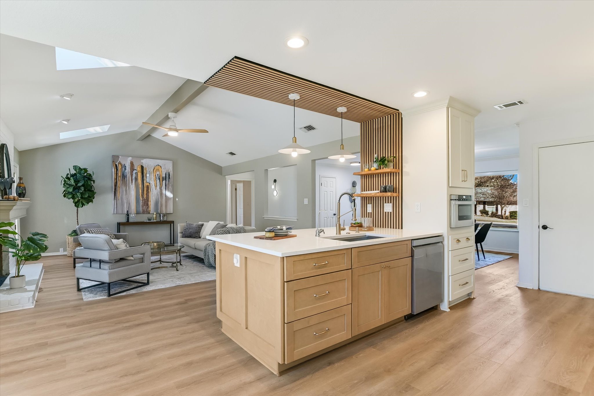 9905 Richelieu Road Austin, TX 78750 - Photo 32 of 32 Kitchen with pendant lighting, light wood look flooring, open floor plan, and light brown cabinetry